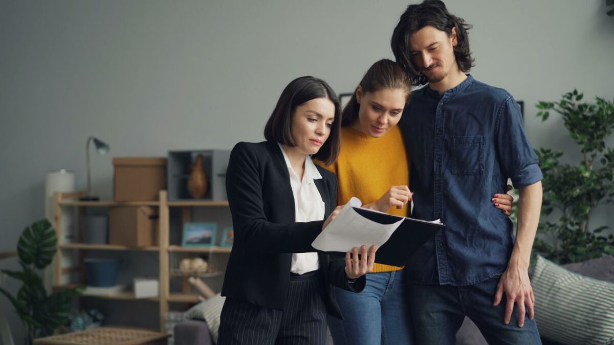 Promotion Rue 66 Young couple consulting with a real estate agent about property one indoors.